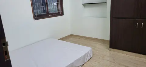 Second bedroom with a floor mattress, grilled window and built-in wardrobe