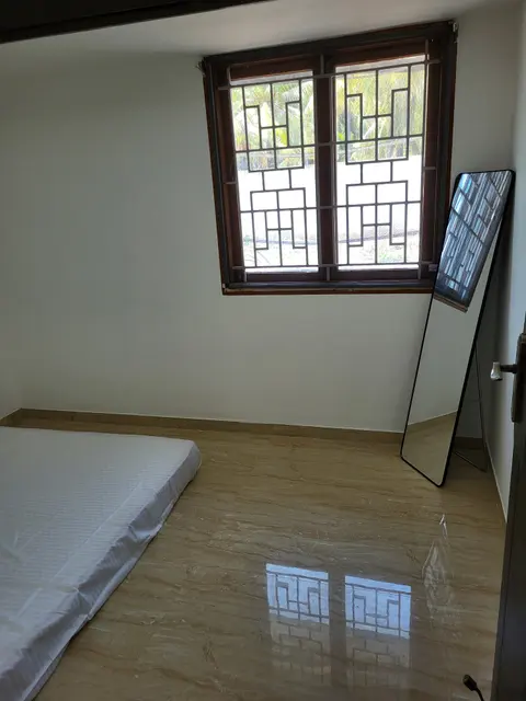 Second bedroom with a floor mattress, grilled window and standing mirror